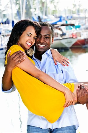Man carrying his girlfriend standing at harbor Stock Photo - Budget Royalty-Free & Subscription, Code: 400-04155053