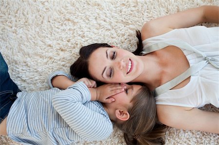 simsearch:400-04654755,k - Smiling mother and her daughter lying on the floor with their heads together Foto de stock - Super Valor sin royalties y Suscripción, Código: 400-04157506