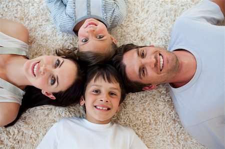 simsearch:400-04654755,k - Happy family lying on the floor with heads together Foto de stock - Super Valor sin royalties y Suscripción, Código: 400-04157510