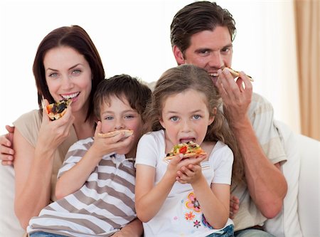 simsearch:400-04193348,k - Happy family eating pizza in living-room all together Stock Photo - Budget Royalty-Free & Subscription, Code: 400-04157558