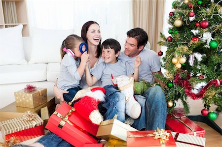 Happy family playing with Christmas gifts at home Stock Photo - Budget Royalty-Free & Subscription, Code: 400-04157711