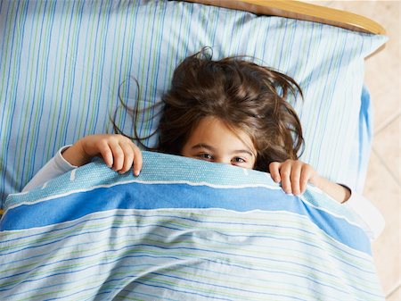 Girl under covers, looking at camera. High angle view Stock Photo - Budget Royalty-Free & Subscription, Code: 400-04158102