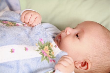 Portrait of adorable baby lying in bed Stock Photo - Budget Royalty-Free & Subscription, Code: 400-04158353
