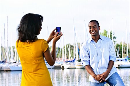 Handsome man posing for vacation photo at harbor with sailboats Stock Photo - Budget Royalty-Free & Subscription, Code: 400-04158550