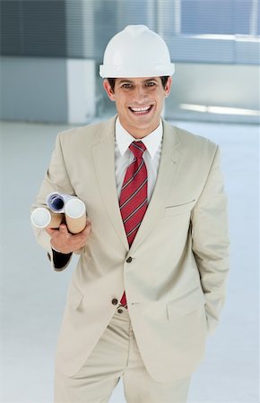Attractive architect holding blueprints in a building site Stock Photo - Budget Royalty-Free & Subscription, Code: 400-04159657