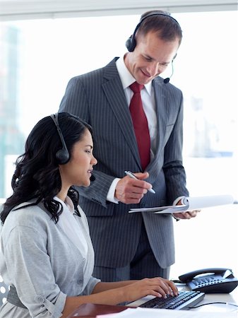 Manager talking to an ethnic businesswoman with a headset on in a call center Stock Photo - Budget Royalty-Free & Subscription, Code: 400-04150249