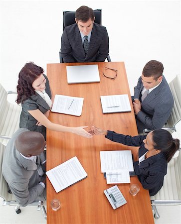 High angle of businesswomen shaking hands in a meeting with more people Stock Photo - Budget Royalty-Free & Subscription, Code: 400-04150371