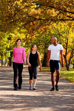 Three people walking in a park, getting some exercise Stock Photo - Budget Royalty-Free & Subscription, Code: 400-04150708