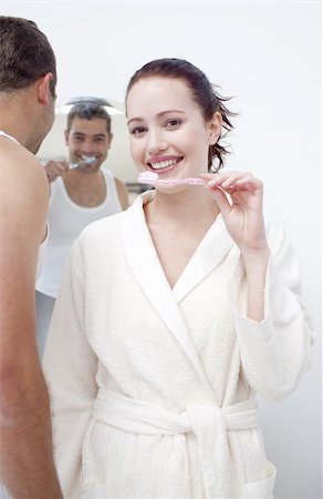 simsearch:400-04151135,k - Attractive woman and man cleaning their teeth in bathroom Stock Photo - Budget Royalty-Free & Subscription, Code: 400-04151126