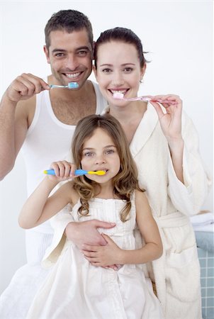 simsearch:400-04151137,k - Happy parents and daughter cleaning their teeth together in bathroom Photographie de stock - Aubaine LD & Abonnement, Code: 400-04151130