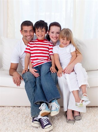 simsearch:400-04193348,k - Family in living-room sitting on sofa together Stock Photo - Budget Royalty-Free & Subscription, Code: 400-04151981