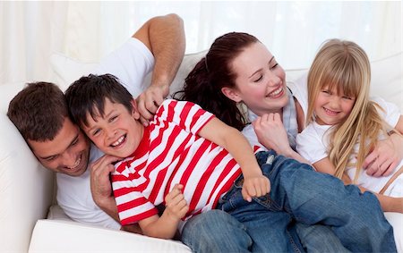 simsearch:400-04193348,k - Family in living-room playing on sofa together Stock Photo - Budget Royalty-Free & Subscription, Code: 400-04151998