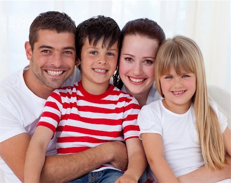 simsearch:400-04193348,k - Portrait of happy family in living-room sitting on sofa together Stock Photo - Budget Royalty-Free & Subscription, Code: 400-04151992