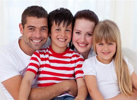 simsearch:400-04193348,k - Portrait of smiling family in living-room sitting on sofa together Stock Photo - Budget Royalty-Free & Subscription, Code: 400-04151993