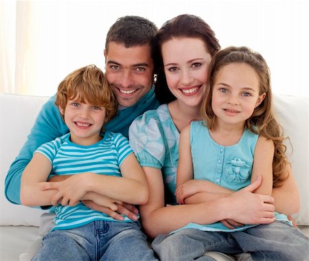simsearch:400-04193348,k - Family in living-room sitting on sofa together Stock Photo - Budget Royalty-Free & Subscription, Code: 400-04152000