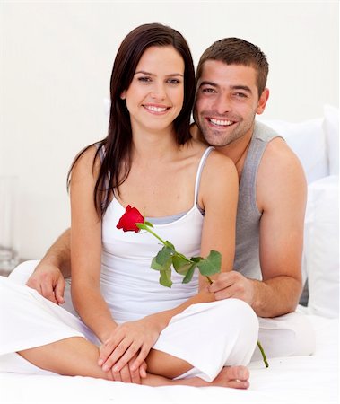 Happy couple sitting on bed with a rose Stock Photo - Budget Royalty-Free & Subscription, Code: 400-04152078