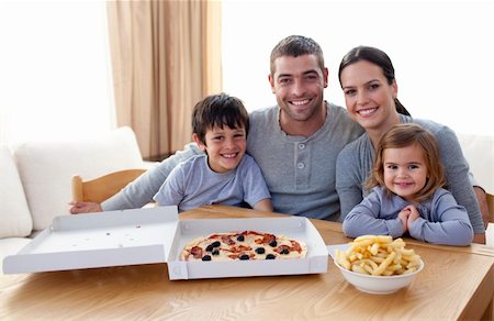 simsearch:400-04193348,k - Happy family eating pizza and fries at home Stock Photo - Budget Royalty-Free & Subscription, Code: 400-04152145