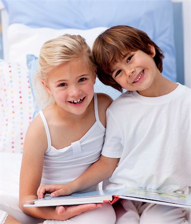 Happy little brother and sister reading a book in bedroom Stock Photo - Budget Royalty-Free & Subscription, Code: 400-04152186