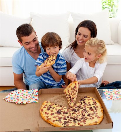 simsearch:400-04193348,k - Happy young family eating pizza in living-room all together Stock Photo - Budget Royalty-Free & Subscription, Code: 400-04152235
