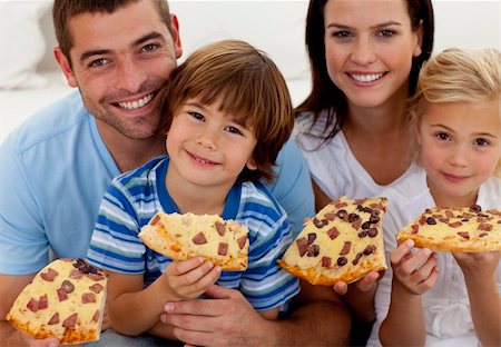 simsearch:400-04193348,k - Portrait of family eating pizza on sofa at home Stock Photo - Budget Royalty-Free & Subscription, Code: 400-04152233