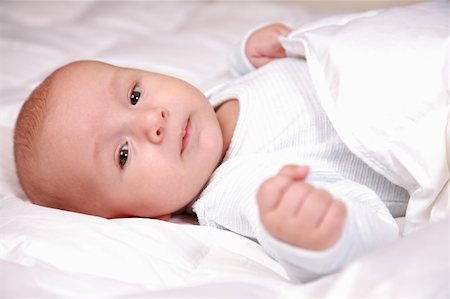 Portrait of adorable baby lying in bed Stock Photo - Budget Royalty-Free & Subscription, Code: 400-04164527