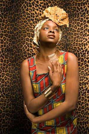 Portrait of an African American woman wearing traditional African clothing in front of a patterned wall. Vertical format. Stock Photo - Budget Royalty-Free & Subscription, Code: 400-04164695