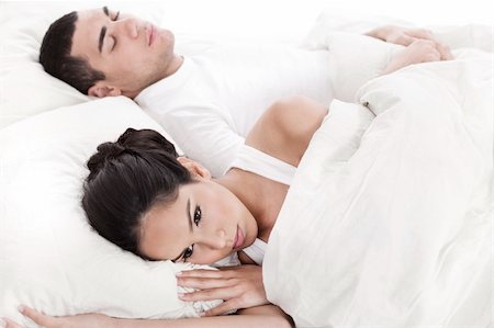 simsearch:400-04341692,k - Couple in bed, men sleeping and woman lying disappointed in white background Stock Photo - Budget Royalty-Free & Subscription, Code: 400-04165092