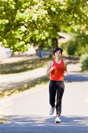 simsearch:400-04128723,k - Woman running in park Photographie de stock - Aubaine LD & Abonnement, Code: 400-04167709