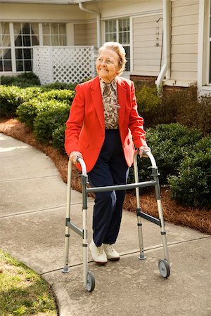 Smiling elderly woman takes a stroll outdoors with her walker.  Vertical shot. Stock Photo - Budget Royalty-Free & Subscription, Code: 400-04167950