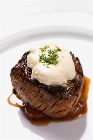 Beef filet dinner entree with garnish and brown sauce displayed on a white dinner plate. Vertical shot. Stock Photo - Budget Royalty-Free & Subscription, Code: 400-04168239