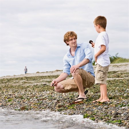 Father and son gathering rocks at beach Stock Photo - Budget Royalty-Free & Subscription, Code: 400-04168659