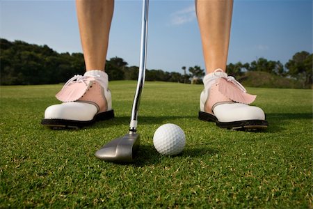 feet only - Closeup of a woman golfer about to make a putt. Horizontal shot. Stock Photo - Budget Royalty-Free & Subscription, Code: 400-04168913