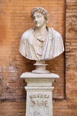 simsearch:400-05338054,k - Carved bust statue standing in front of a brick wall. Vertical shot. Stock Photo - Budget Royalty-Free & Subscription, Code: 400-04168966