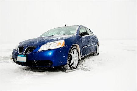 Blue sedan caked in ice and snow sits parked amongst a winter backdrop. Horizontal shot. Stock Photo - Budget Royalty-Free & Subscription, Code: 400-04169297