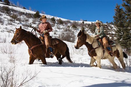 Man and young woman riding horses in deep snow across a country landscape. Horizontal shot. Stock Photo - Budget Royalty-Free & Subscription, Code: 400-04169410