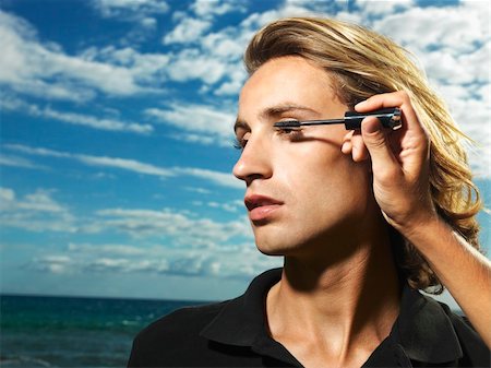 Young man with wind blown hair having mascara applied with the ocean in the background. Horizontal shot. Stock Photo - Budget Royalty-Free & Subscription, Code: 400-04169639