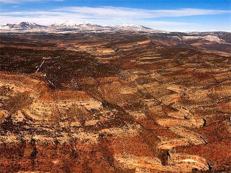 simsearch:400-03948680,k - Aerial view of an arid, craggy landscape with mountains in the background. Horizontal shot. Stock Photo - Budget Royalty-Free & Subscription, Code: 400-04169679
