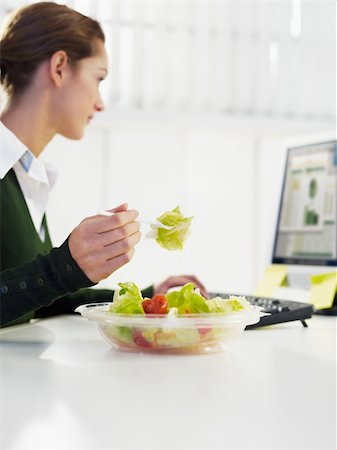 woman eating salad in office. Copy space Stock Photo - Budget Royalty-Free & Subscription, Code: 400-04160537