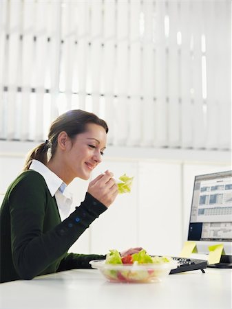 woman eating salad in office. Copy space Stock Photo - Budget Royalty-Free & Subscription, Code: 400-04160539