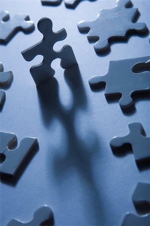 Backlit jigsaw puzzle pieces with one standing up and looking anthropomorphic Stock Photo - Budget Royalty-Free & Subscription, Code: 400-04160628