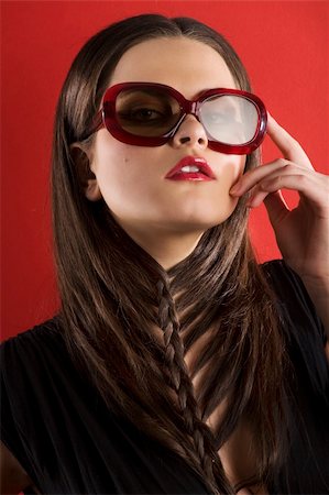 simsearch:400-04754019,k - young brunette on red background wearing sunglasses and black dress with a creative hair stylish Stock Photo - Budget Royalty-Free & Subscription, Code: 400-04176531