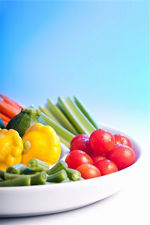 Selection of fresh veg on a spiral white plate. Stock Photo - Budget Royalty-Free & Subscription, Code: 400-04176561