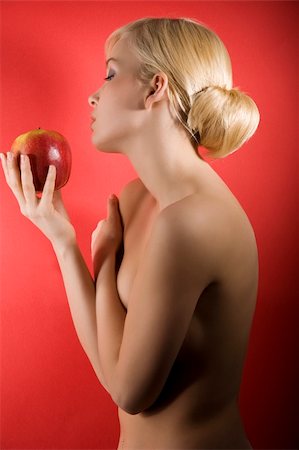 simsearch:400-04836564,k - fashion shot of a glamour sensual girl looking a red apple against colored background Stock Photo - Budget Royalty-Free & Subscription, Code: 400-04179748