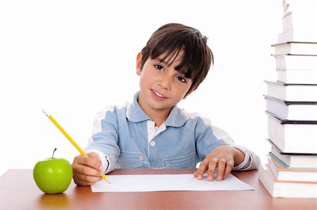 simsearch:400-04924737,k - School boy doing his homework with an apple beside him on white background Stock Photo - Budget Royalty-Free & Subscription, Code: 400-04171498