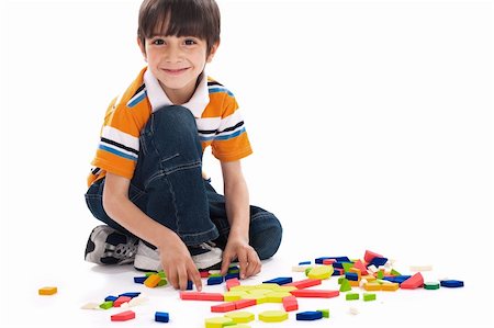 simsearch:400-04638236,k - Adorable caucasian boy joining the blocks while playing on white background Photographie de stock - Aubaine LD & Abonnement, Code: 400-04171510
