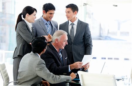 simsearch:400-04184165,k - Multi-ethnic business team studying a document in a meeting Stock Photo - Budget Royalty-Free & Subscription, Code: 400-04184148