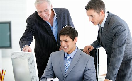simsearch:400-04184165,k - Positive businessmen working at a computer in the office Stock Photo - Budget Royalty-Free & Subscription, Code: 400-04184158