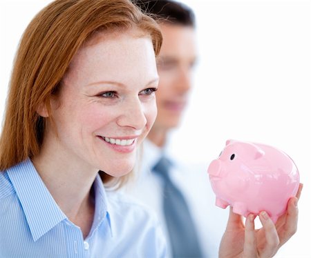 simsearch:400-04184165,k - Smiling businesswoman holding a piggybank in the office Stock Photo - Budget Royalty-Free & Subscription, Code: 400-04184165