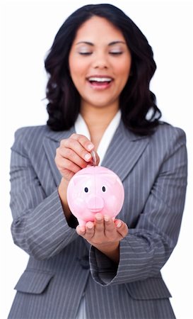 simsearch:400-04184165,k - Positive businesswoman saving money in a piggybank against a white background Stock Photo - Budget Royalty-Free & Subscription, Code: 400-04184199