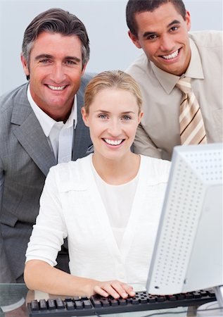 Positive business team working at a computer in the office Stock Photo - Budget Royalty-Free & Subscription, Code: 400-04184234